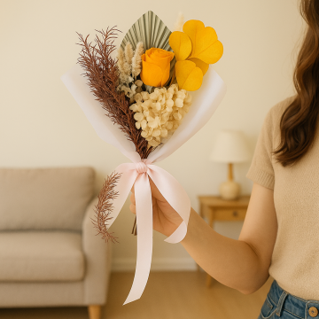 Preserved bouquet with orange infinity rose yellow preserved apple leaves and hydrangea displayed in a cozy living room.