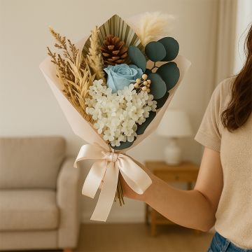 Infinity Rose bouquet in an elegant lifestyle setting with preserved hydrangea eucalyptus and pampas grass.