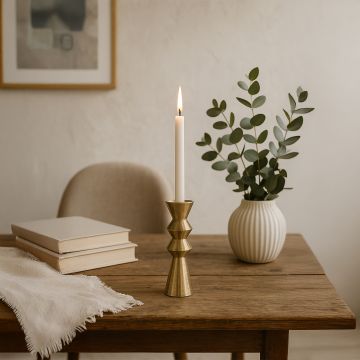 Gold metal candle holder adding warm modern decor to a living room console table for elegant home styling.