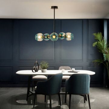 Modern black and gold chandelier with blue glass globes adding elegance and soft luxury lighting to contemporary home interiors.