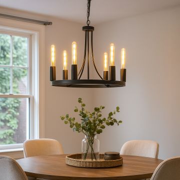 Modern black metal chandelier with exposed Edison tube bulbs hanging in interior space creating industrial vintage lighting.