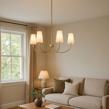 Elegant brass gold chandelier with white fabric cone shades hanging in interior space creating sophisticated modern lighting.