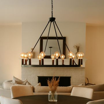 Modern black metal ring chandelier with exposed Edison globe bulbs hanging in interior space creating industrial lighting.