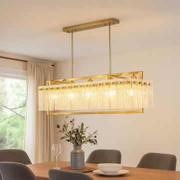Gold crystal chandelier with cascading glass accents illuminating elegant dining room creating luxurious modern interior.
