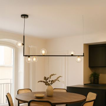 Modern black linear chandelier with clear glass globes styled in a contemporary room creating elegant ambient lighting.