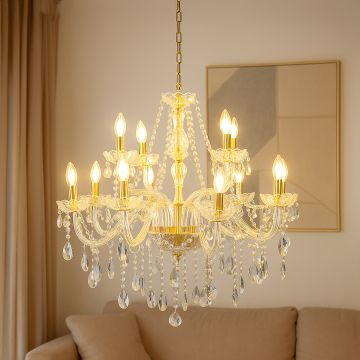 Crystal chandelier with gold accents glowing warmly above sofa in living room for luxury interior decor.