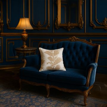 Soft cotton cushion cover with beige and brown floral embroidery displayed on a navy sofa creating a refined elegant décor accent with a breathable gentle and skin friendly fabric feel.