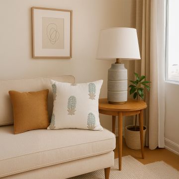 Soft cotton cushion covers with subtle botanical embroidery styled on a neutral sofa offering a warm natural décor accent with breathable gentle and skin friendly fabric quality for cozy interiors.