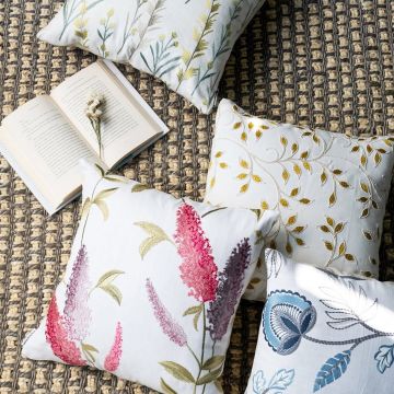 Soft cotton cushion covers in assorted botanical designs displayed on a textured surface offering a vibrant nature inspired décor feel with breathable gentle and skin friendly fabrics.
