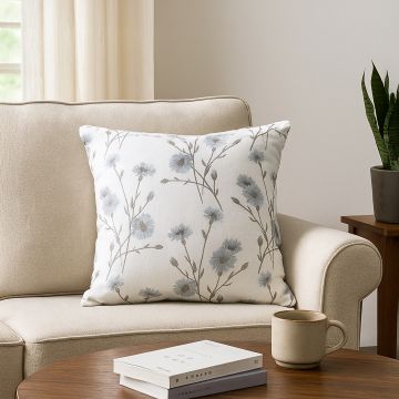 Floral cushion with soft blue flower pattern adding cozy natural charm to modern living space decor.