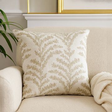 Elegant beige embroidered cushion adding a soft natural accent to modern home decor styling.
