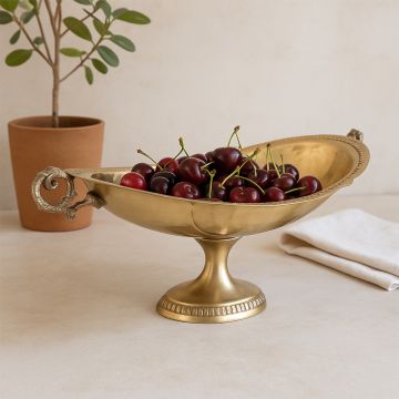 Hammered finish gold fruit bowl with pedestal base and twin handles shown on a plain white background surface.