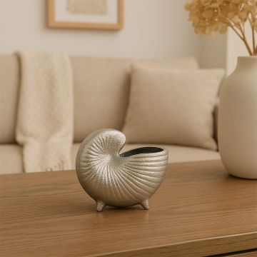 Silver nautilus shell decor bowl styled in a modern lifestyle setup highlighting its textured metallic finish