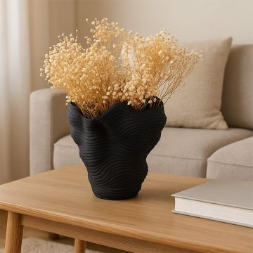 Golden beige dried flowers held in hand in a warm room setting adding soft rustic charm to natural home decor.