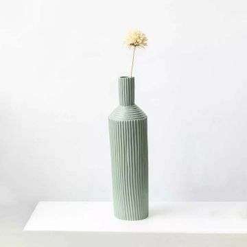 Dried flower arrangement in a tall ceramic vase displayed on a white surface providing a simple calming home décor accent with a minimal natural aesthetic perfect for modern interiors.
