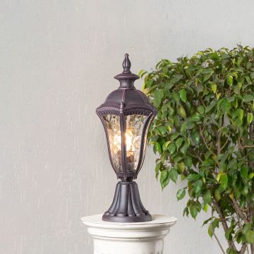 Antique brown pillar light with patterned clear glass displayed on white background for classic outdoor or garden decor.