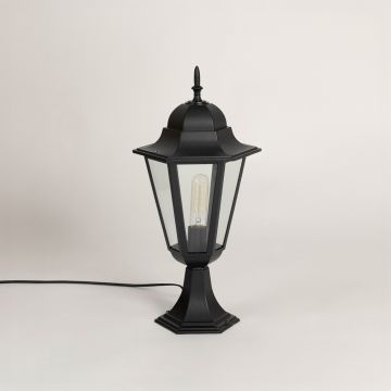 Black pillar lamp with clear glass panels and sleek design shown on white background with light off for outdoor garden decor.