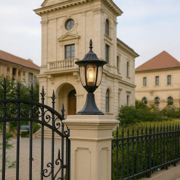 Elegant black pillar lamp glowing warmly on outdoor stone pillar enhancing luxury villa entrance and garden pathway lighting.
