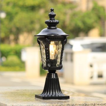 Black pillar light with patterned clear glass adding elegant classic charm to outdoor decor for warm garden and porch lighting.