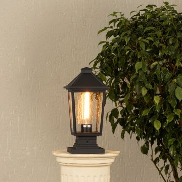 Black metal outdoor post lantern with light on Warm ambient lighting on a decorative pillar Main Lifestyle.