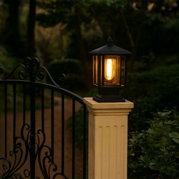 Traditional black metal outdoor lantern mounted on a pillar Light On Warm ambient light Main Lifestyle image at night.