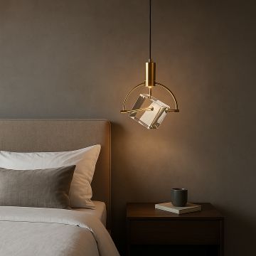 Crystal cube pendant light with golden frame styled in bedroom above bedside table for modern luxury interiors.
