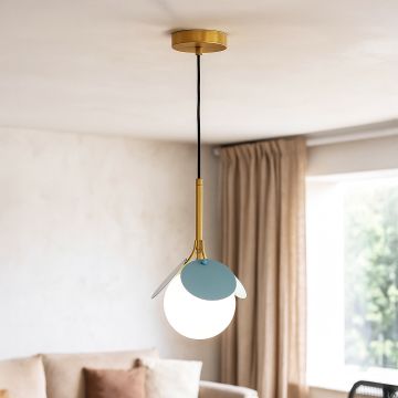 Modern blue pendant light with glass globe shade hanging in cozy living room interior for home decoration.