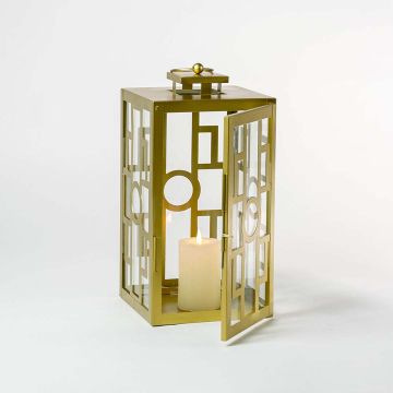 Golden metal lantern illuminated with a soft candle glow on a clean white background highlighting its geometric square and circle pattern with premium craftsmanship.