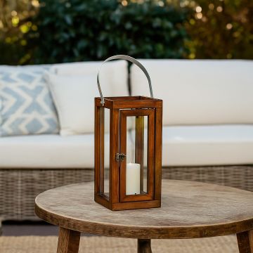 Medium wooden and glass lantern with metal handle shown on white background ideal for modern home and patio decor.