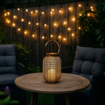 Warm outdoor setting featuring a golden wire lantern on a wooden table with a glowing candle light on creating a cozy evening ambience.