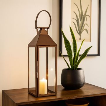 Brown metal lantern with clear glass panels adding warm decorative charm to living space for modern home and garden decor.