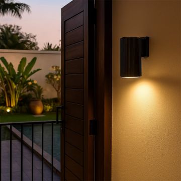 Modern black cylindrical wall light adding a sleek architectural glow and refined elegance to contemporary interiors.