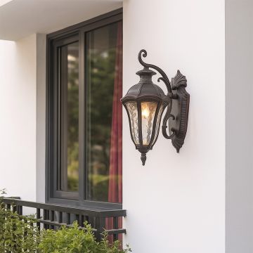 Elegant vintage outdoor wall lantern adding timeless charm to exterior walls with intricate metalwork and classic glass panels.