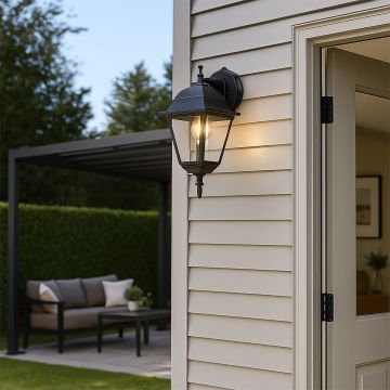 Elegant black outdoor wall lantern enhancing modern exterior walls with warm light and timeless architectural charm.