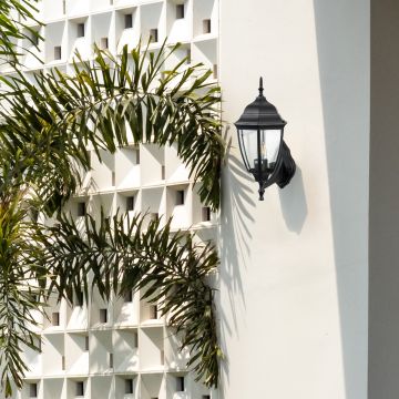 Black upward outdoor wall lantern with clear glass creating classic vintage coach style lighting for traditional exterior.