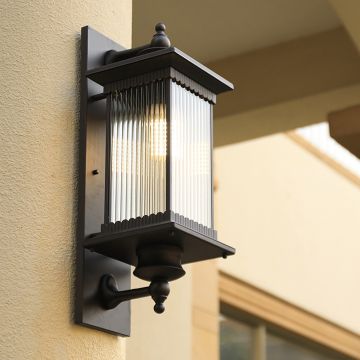 Brown metal outdoor wall lantern with ribbed glass adding elegant lighting to exterior walls for classic home decor.