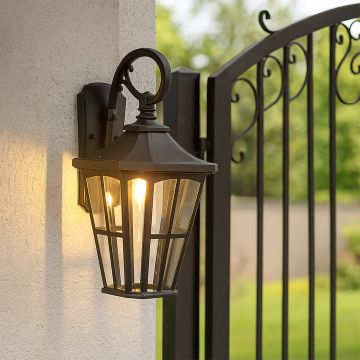 Outdoor lantern gate light illuminating a modern entrance wall with soft warm glow.