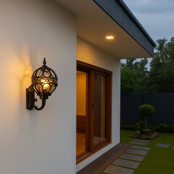 Elegant black metal outdoor wall light glowing warmly on a modern home exterior creating ambient evening lighting for entryway decor.