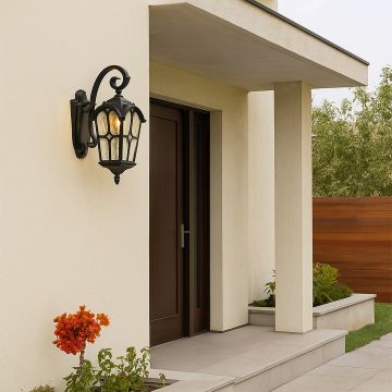 Stylish black outdoor wall lantern mounted on a wall showing its elegant arched design and textured glass.