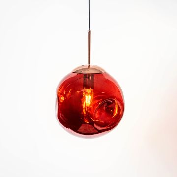 Red glass pendant lamp glowing warmly on white background creating a bold elegant look for modern home interiors.