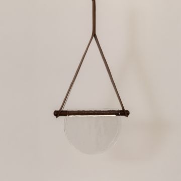 Pendant light with clear half-moon textured glass shade and brown frame illuminated on a clean white background for a bright modern look.