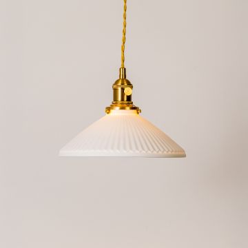 Ribbed white glass pendant light glowing softly with gold metal holder on white background for modern kitchen and home decor.