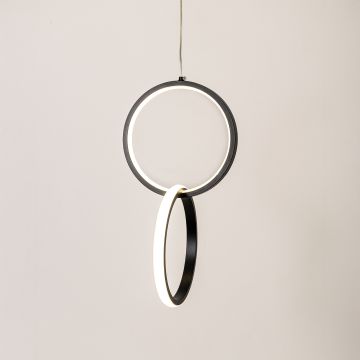 Modern metal dual ring hanging light in black and white glowing softly on white background for elegant wall decor.