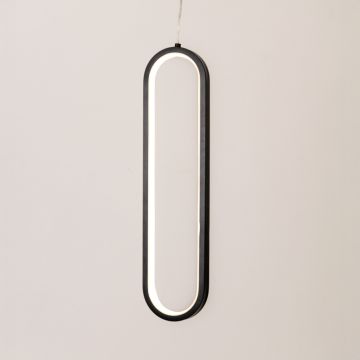 Modern metal elongated loop hanging light in black and white glowing softly on white background for stylish wall decor.