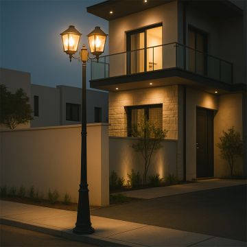 Black metal dual head outdoor lamp post light on illuminating a modern home exterior creating warm pathway lighting ideal for driveway patio and garden Decor.