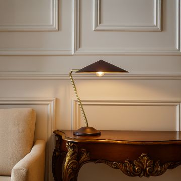 Gold metal table lamp with dark brown shade adding modern elegance to tabletop decor in a stylish living room setting.