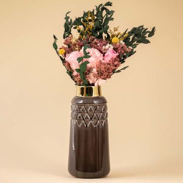 Tall ceramic vase in deep brown with gold rim styled with pink and green florals creating a warm lifestyle decor accent for living room or dining space.