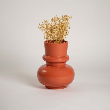 Terracotta orange modern decorative vase styled in a warm interior adding bold contemporary decor to consoles shelves and stylish living spaces.