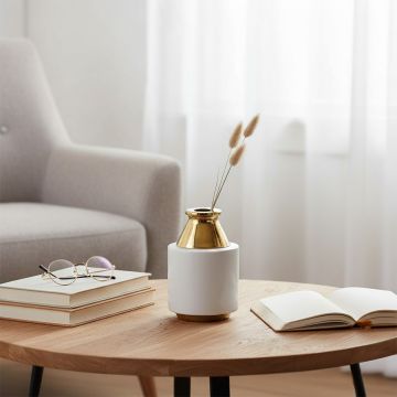 White and gold modern ceramic vase styled on a marble surface ideal for elegant home decor accents and premium interior styling.