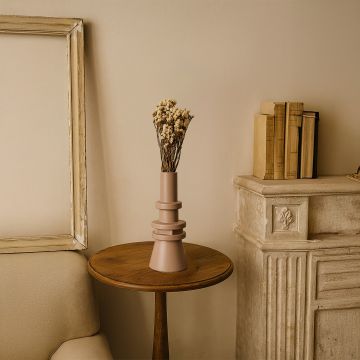 Tall modern beige decorative vase placed in a minimal setting showcasing its sculptural tiered design and smooth matte finish for a stylish contemporary look.